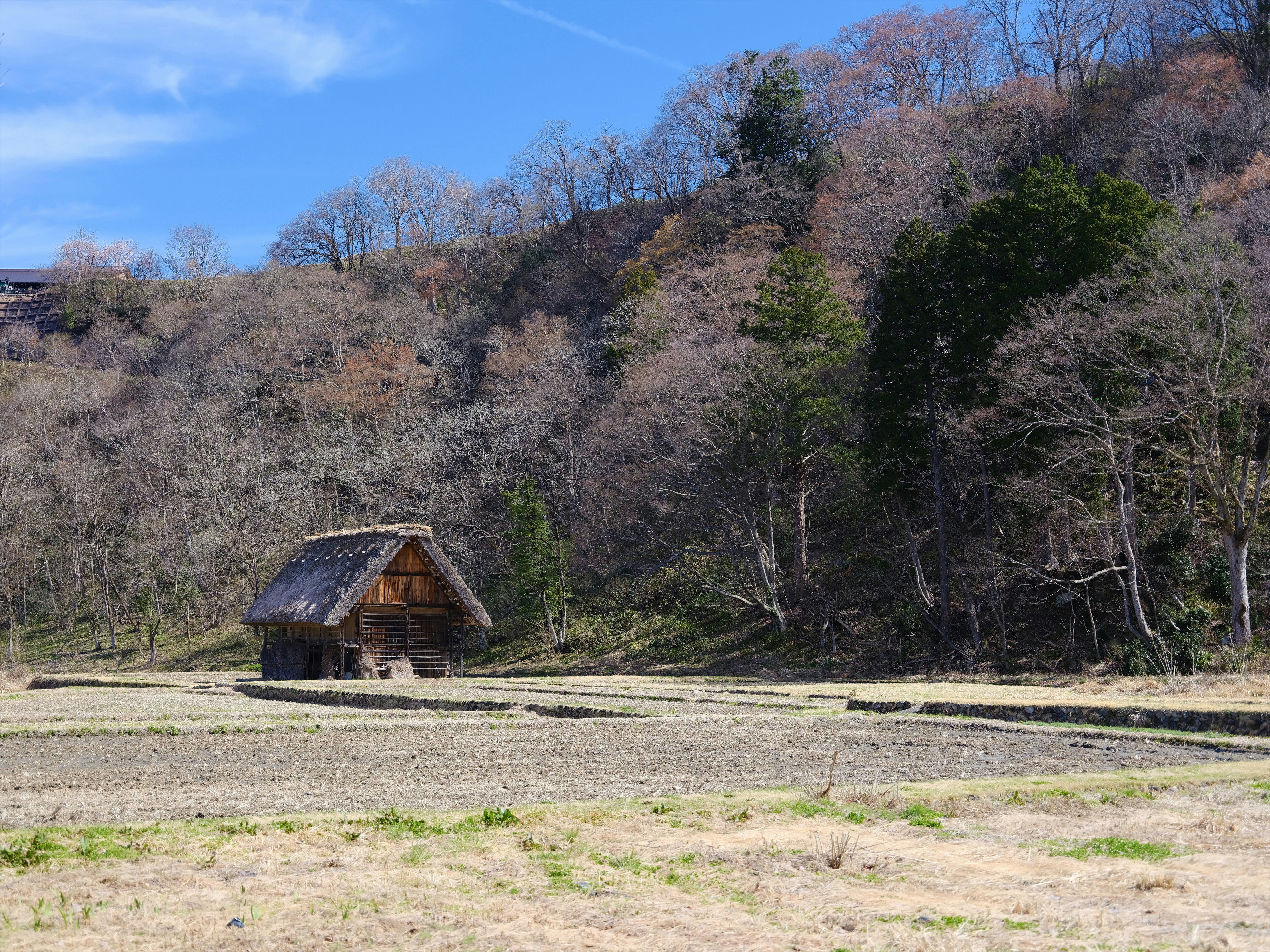 a small cabin in the middle of a field
