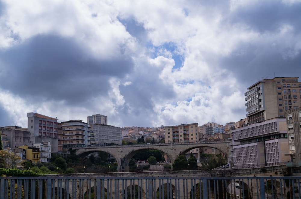 a bridge over a river with buildings in the background