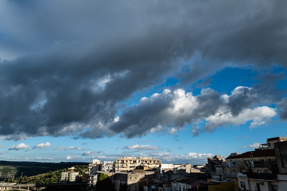 a cloudy sky over a city with buildings