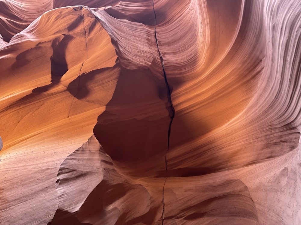 a person standing in a slot in a canyon