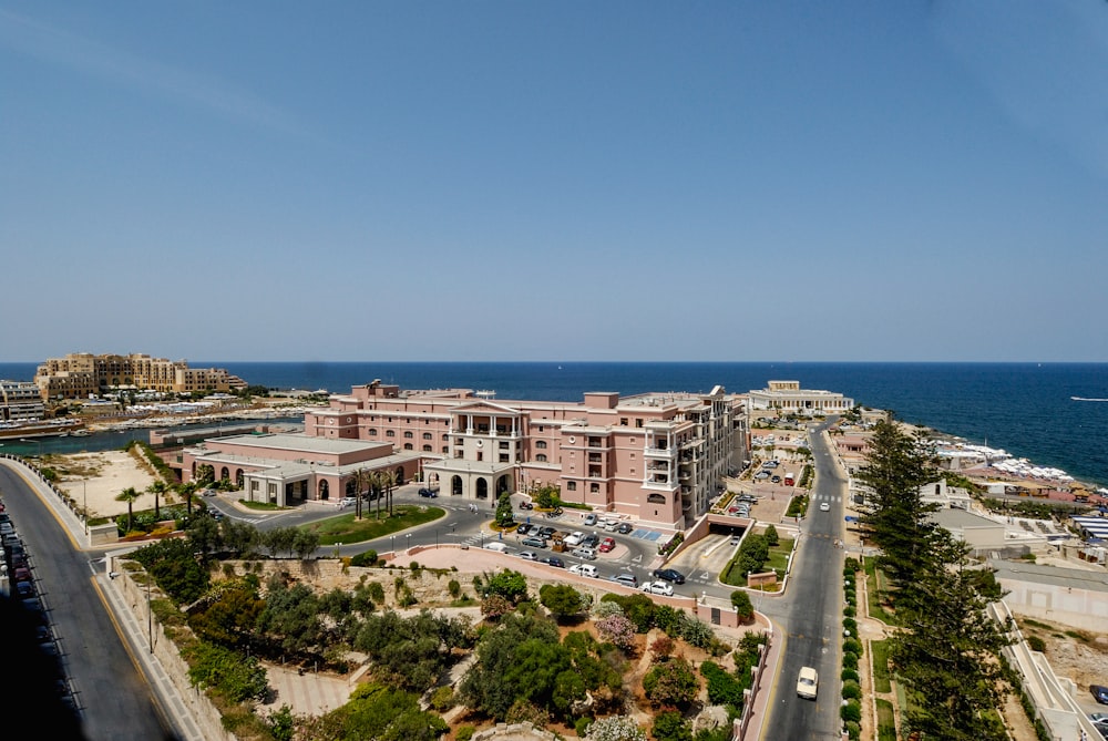 an aerial view of a large building next to the ocean