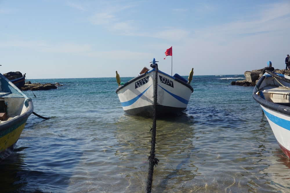 a group of boats sitting on top of a body of water