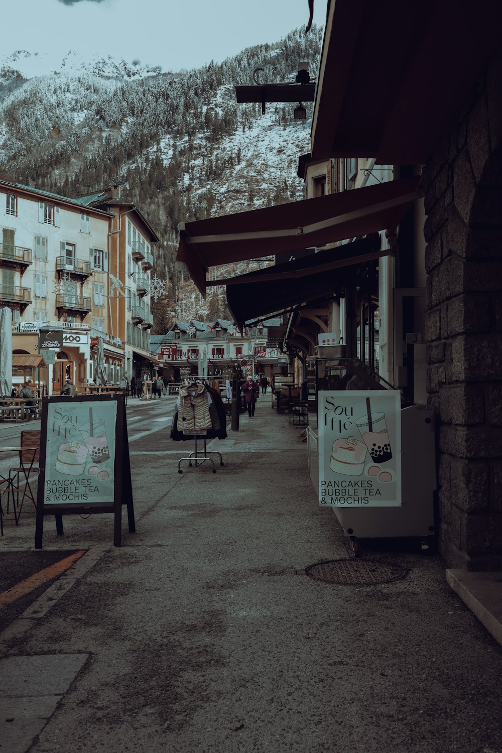 a city street with a mountain in the background