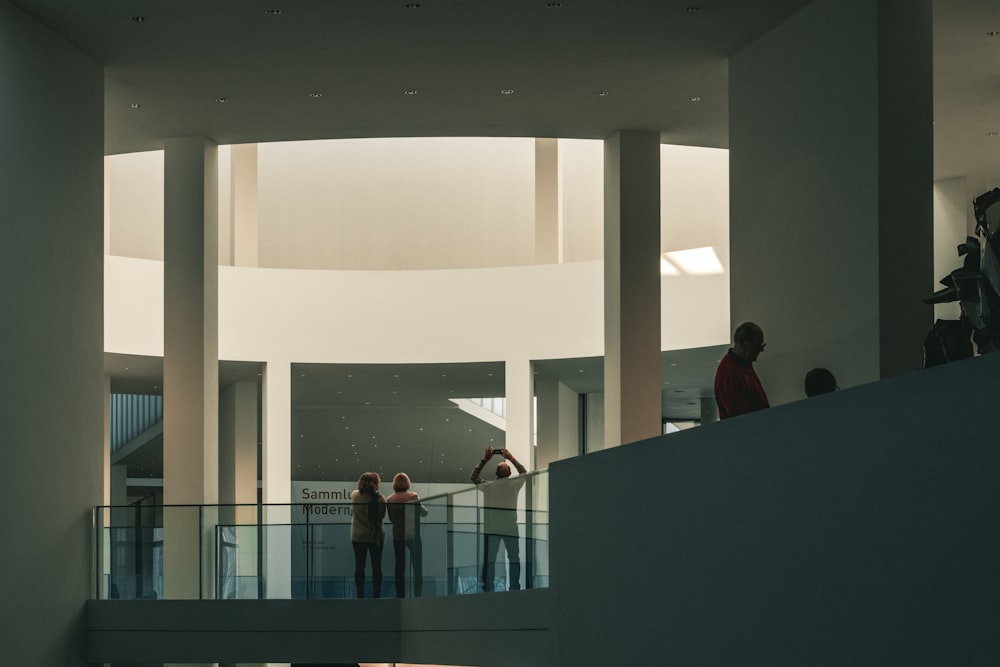 a group of people standing on top of a balcony