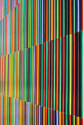 a multicolored wall with vertical lines painted on it
