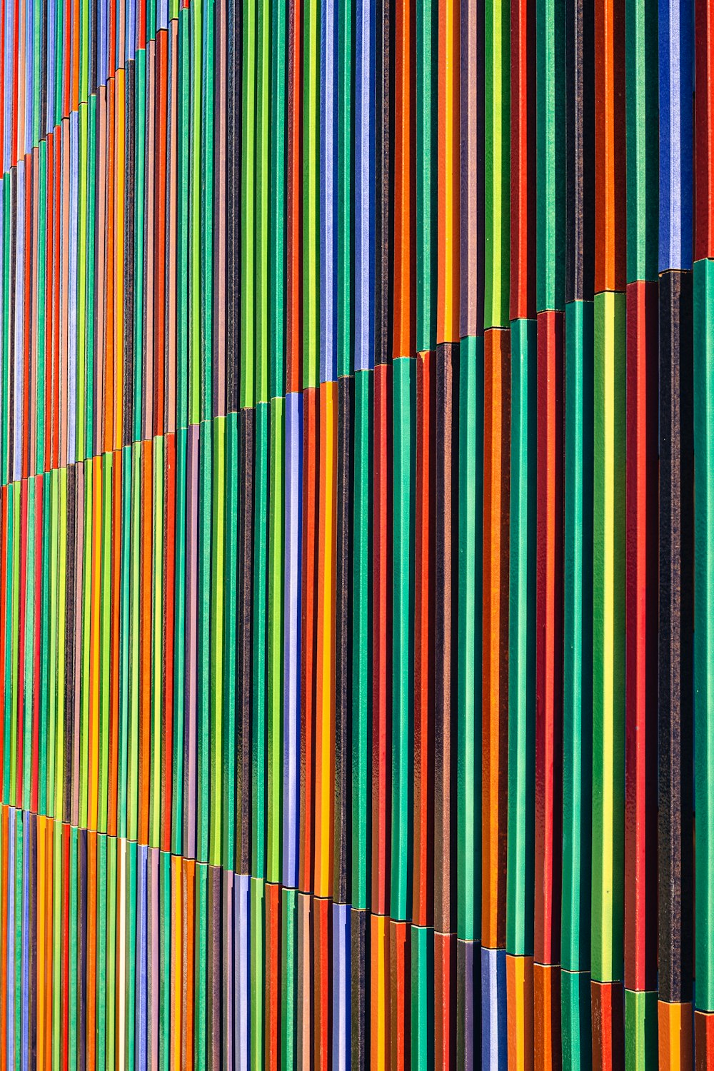 a multicolored wall with vertical lines painted on it