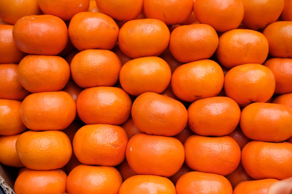 a pile of oranges sitting on top of each other