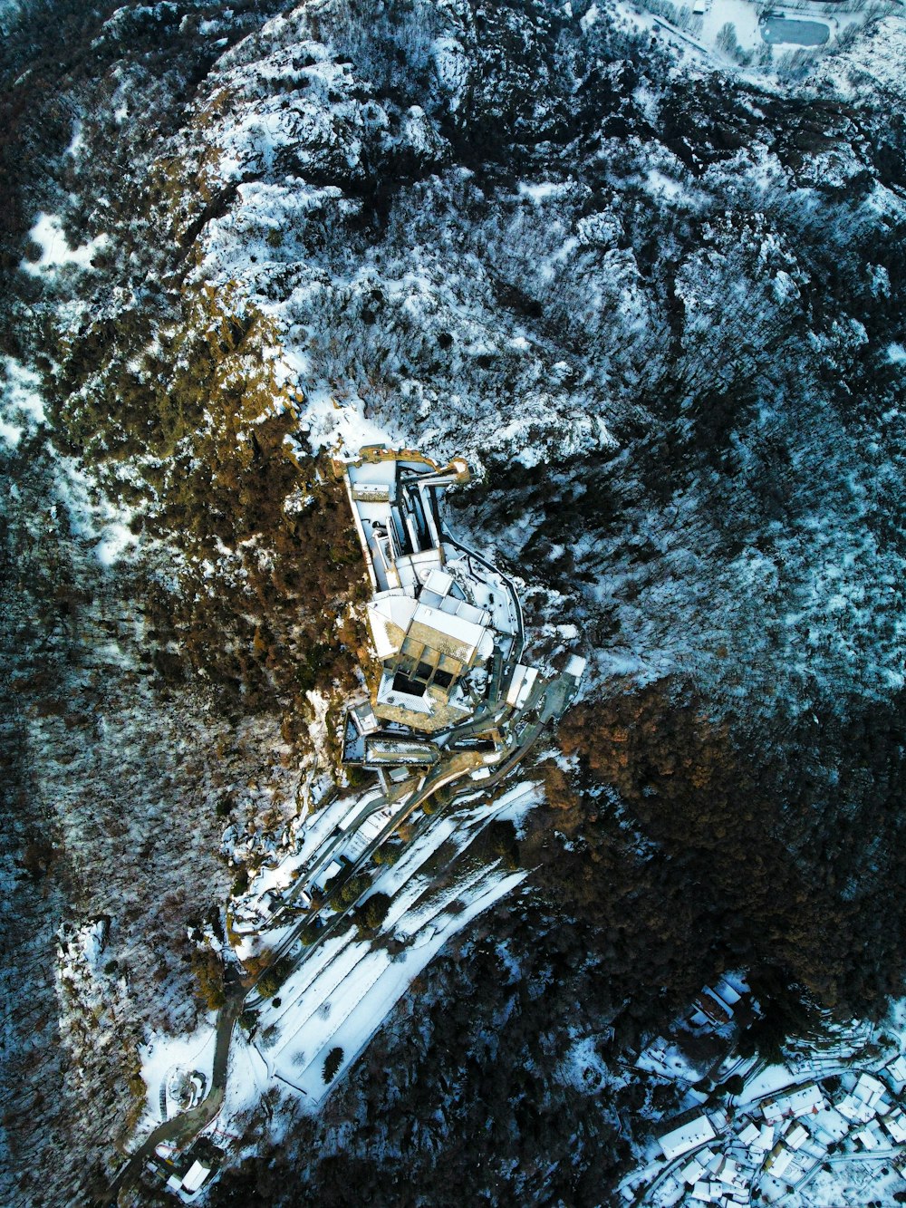 an aerial view of a building in the snow