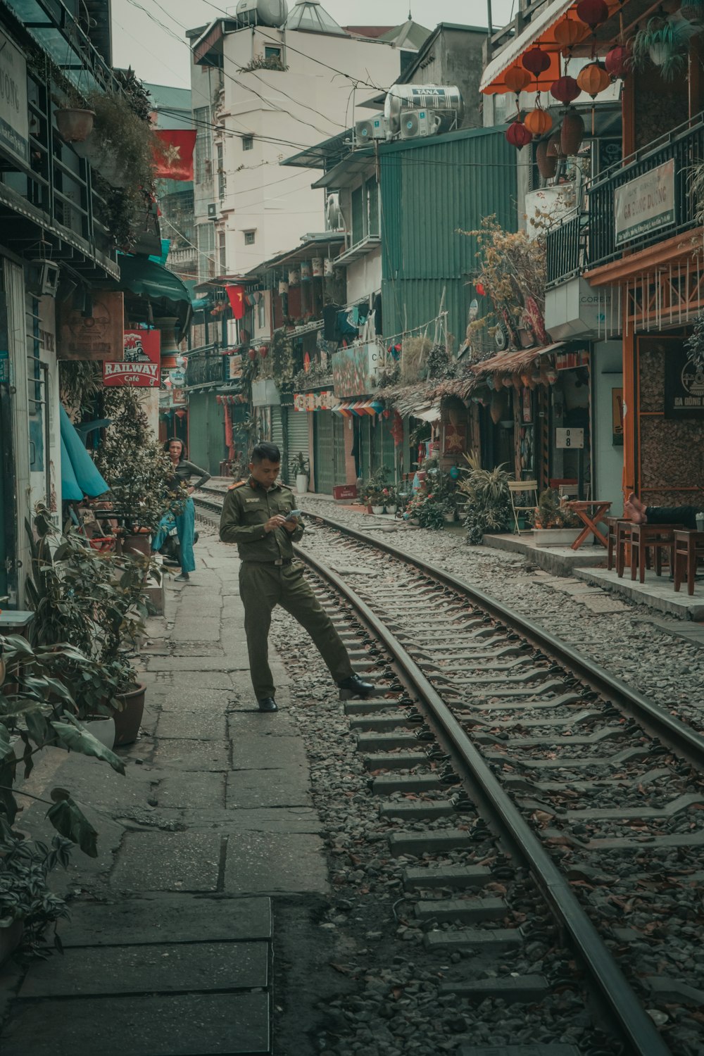 a man standing on a train track in the middle of a city