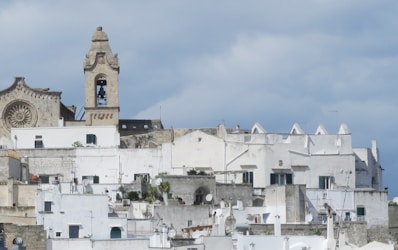 a very tall clock tower towering over a city