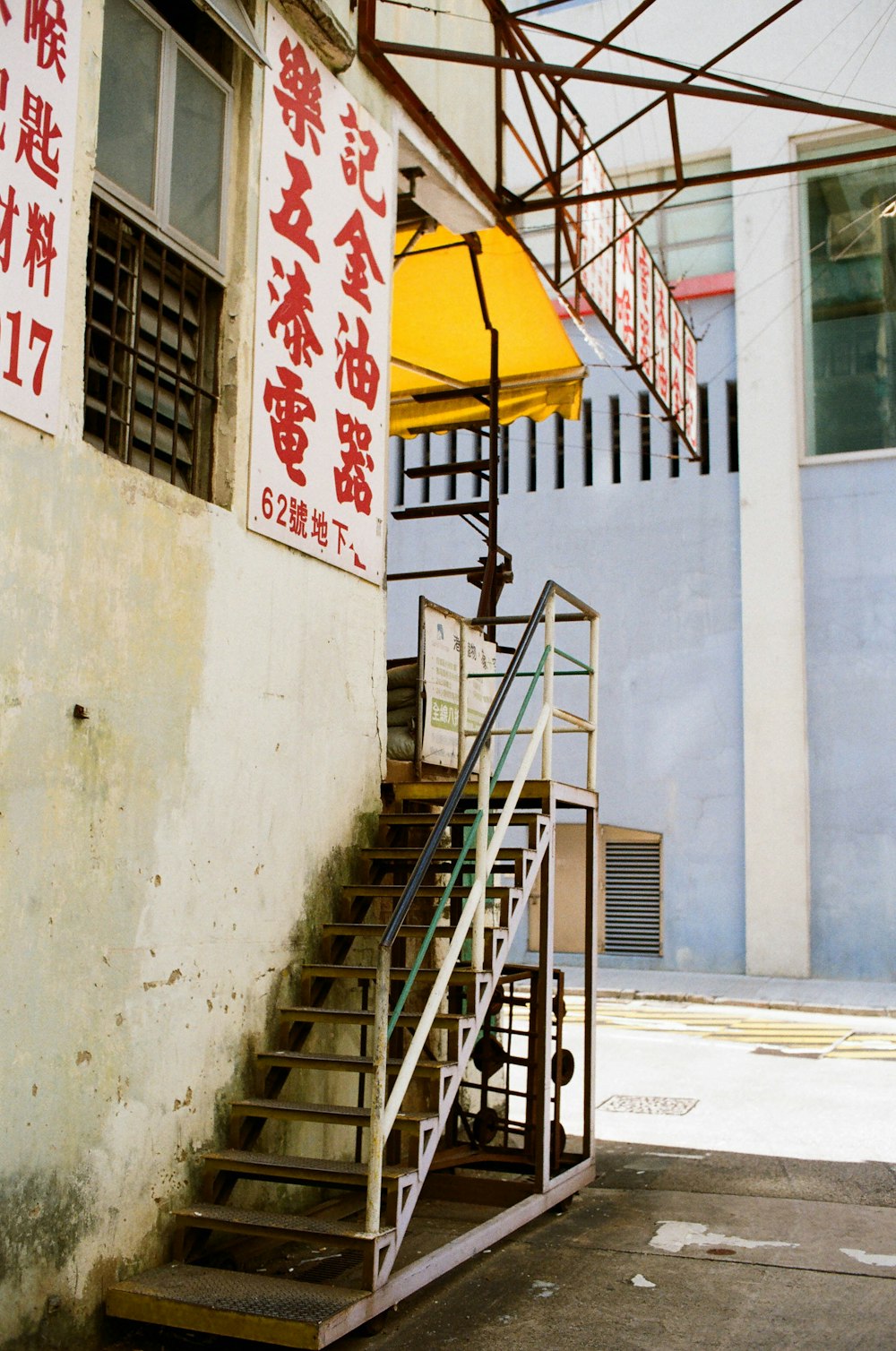 a yellow umbrella sitting on top of a set of stairs