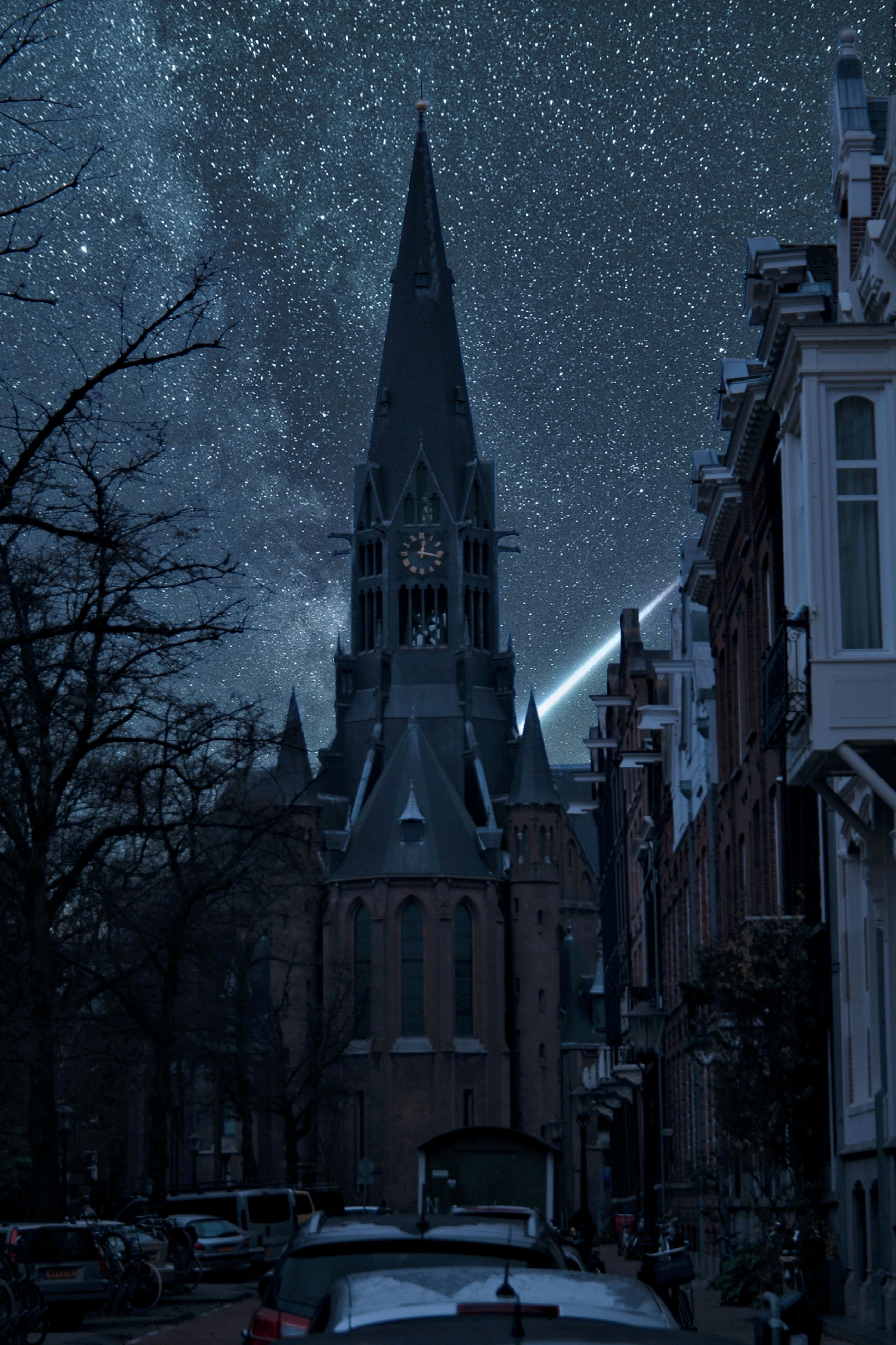 a car parked on the side of a road under a night sky filled with stars