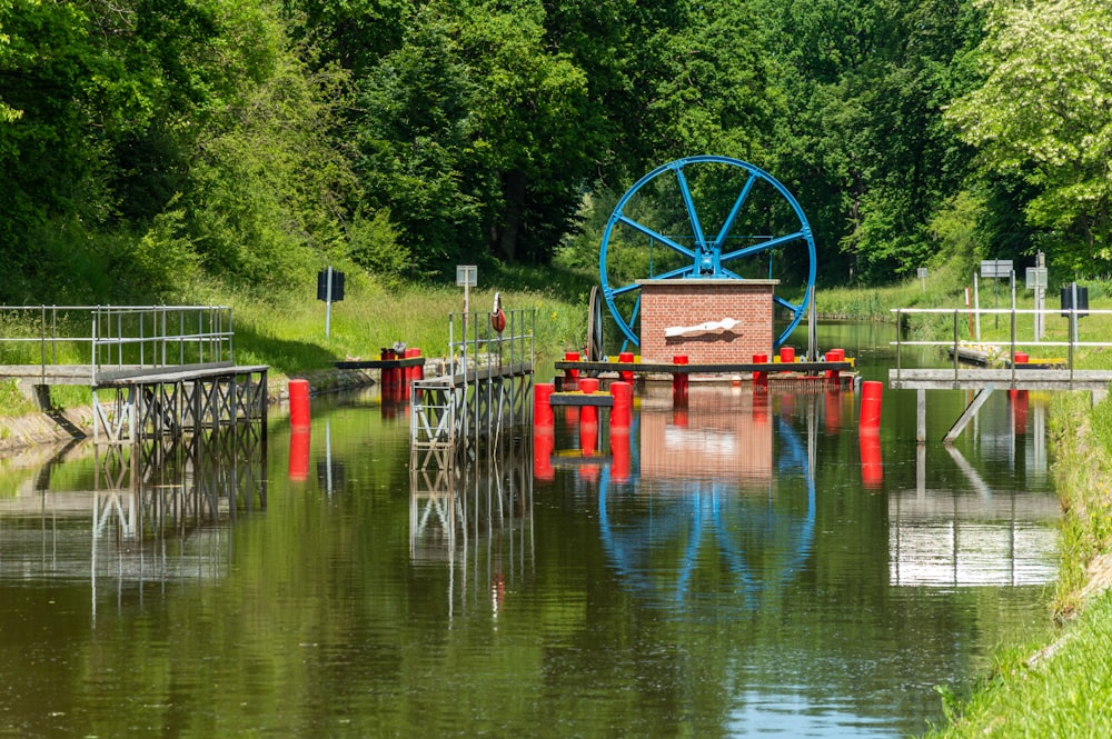 a water way with a water wheel in the middle of it