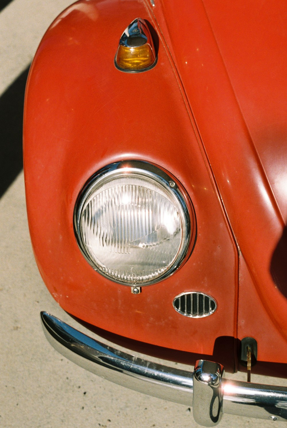 a close up of the front end of a red car