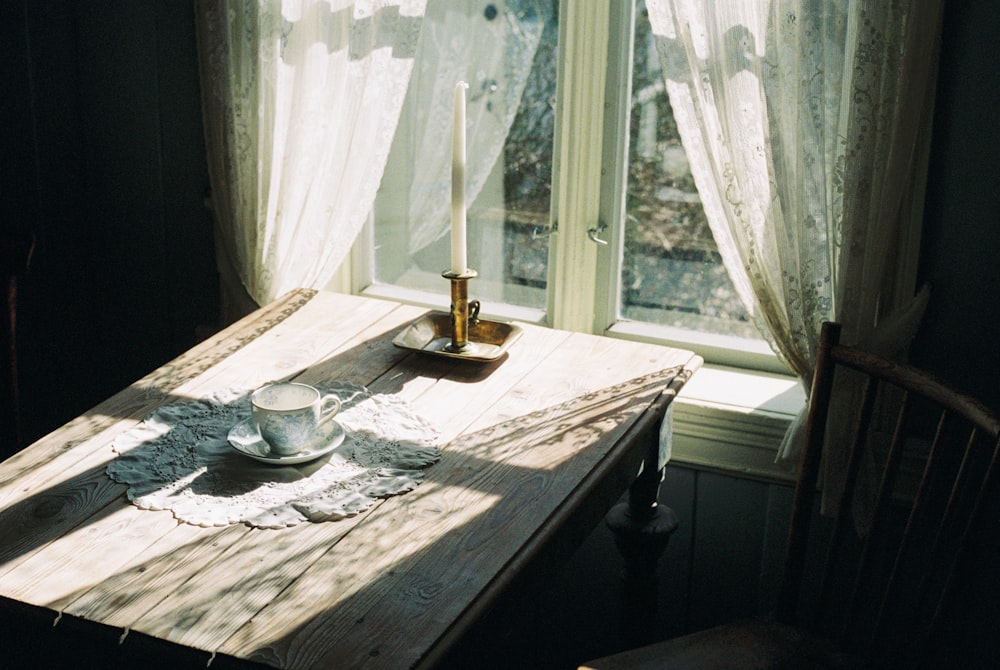 a table with a candle and a plate on it