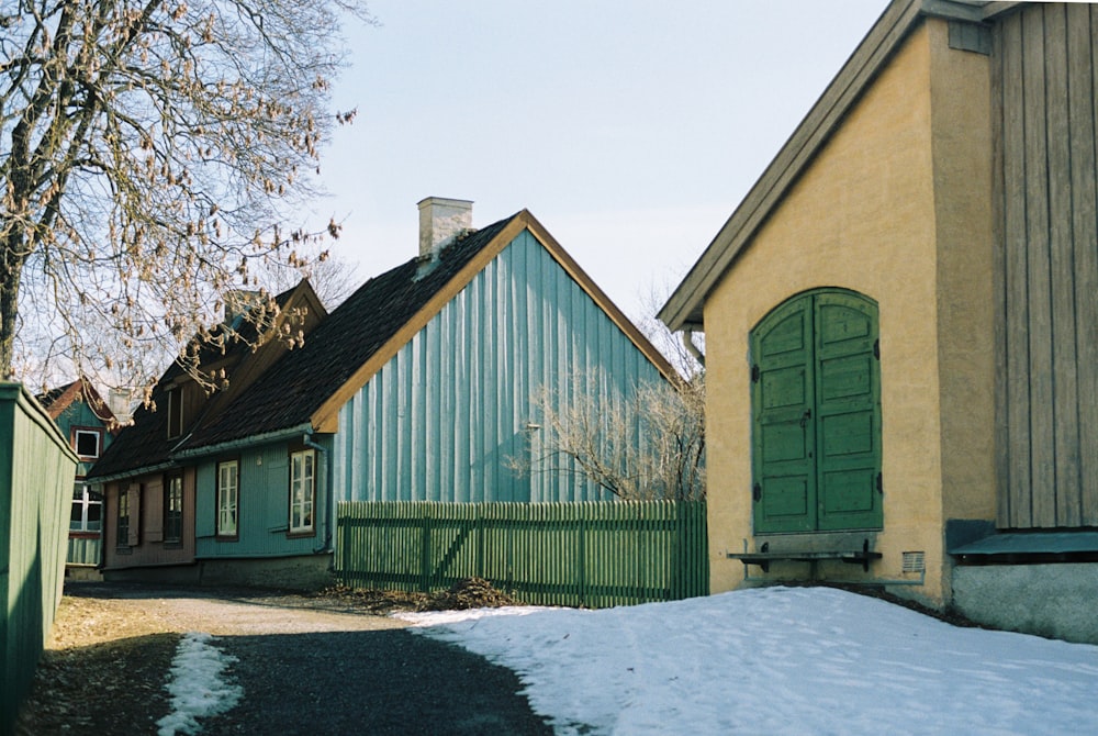 a house with a green door and green shutters