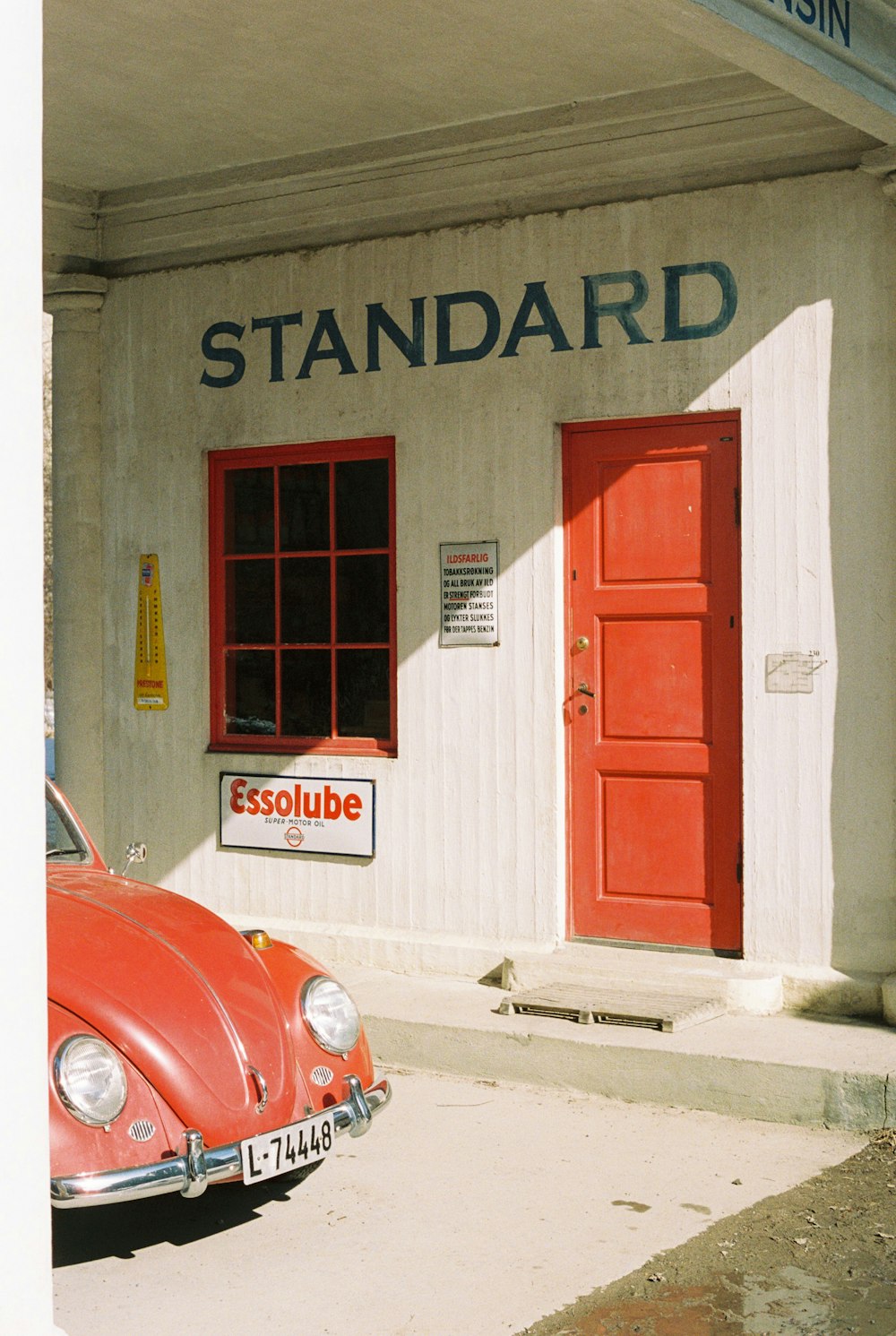 a red car parked in front of a building