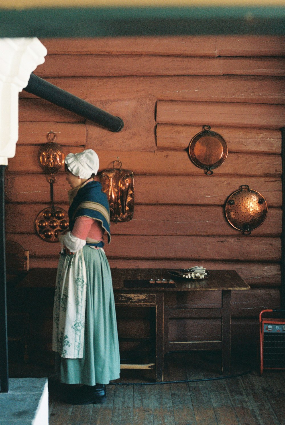 a woman standing in front of a wooden wall