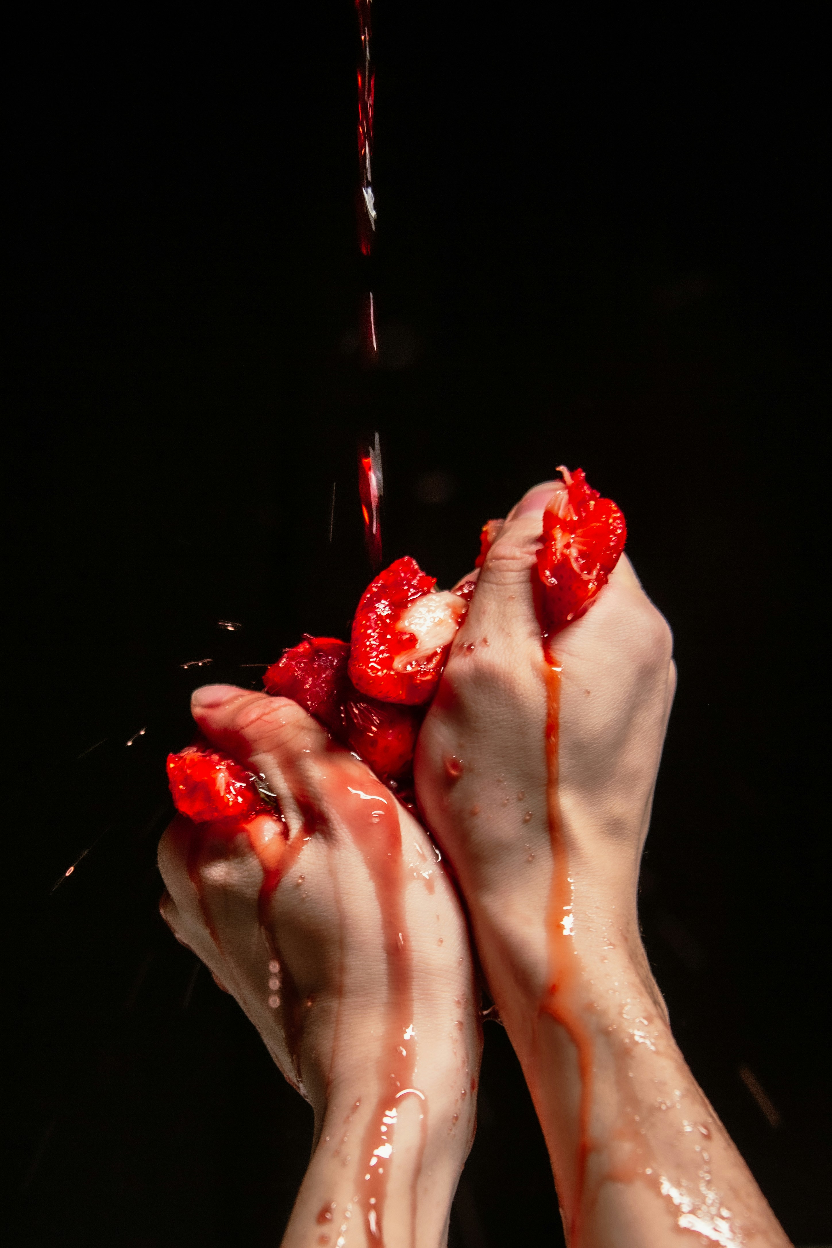 a person is holding some strawberries in their hands