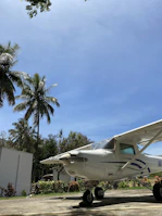 Private airplane ready for takeoff with tropical scenery in the background