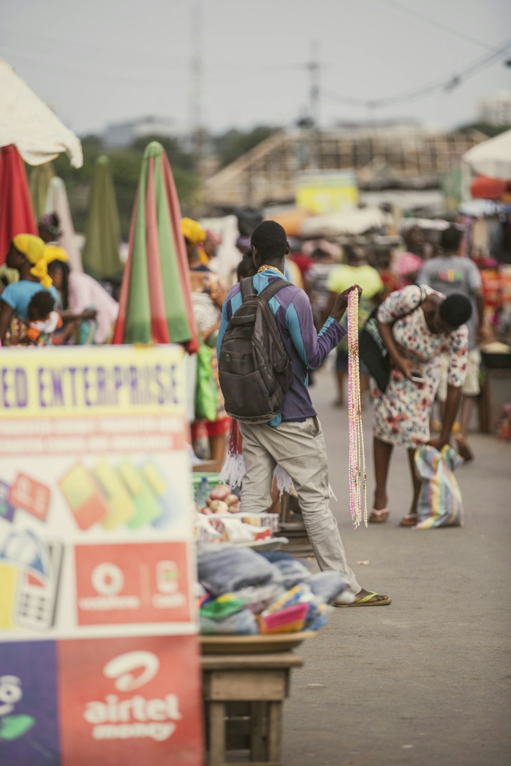 a group of people standing around a market