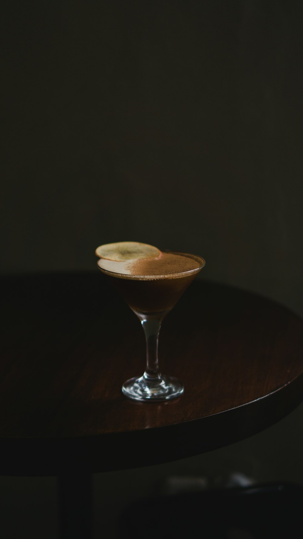 a drink sitting on top of a wooden table