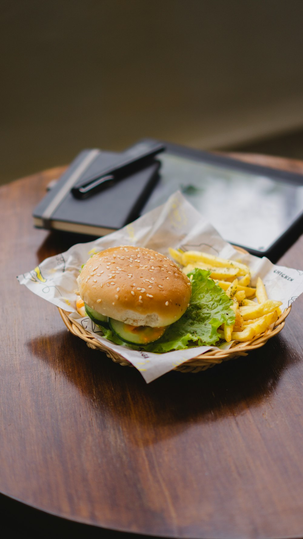 a hamburger and french fries in a basket on a table