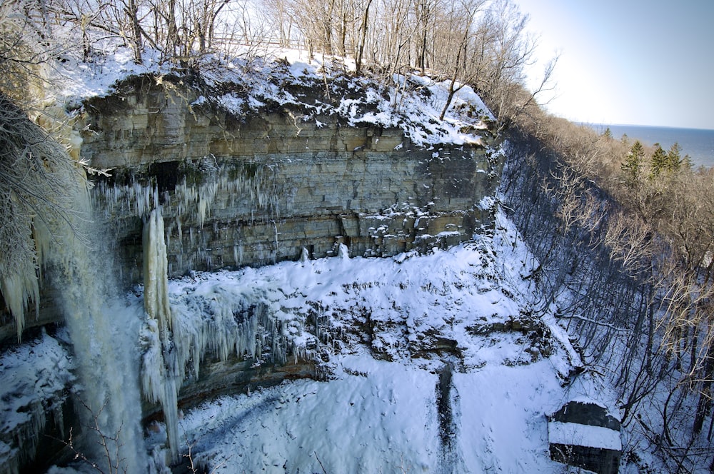a cliff with ice hanging off of it's sides