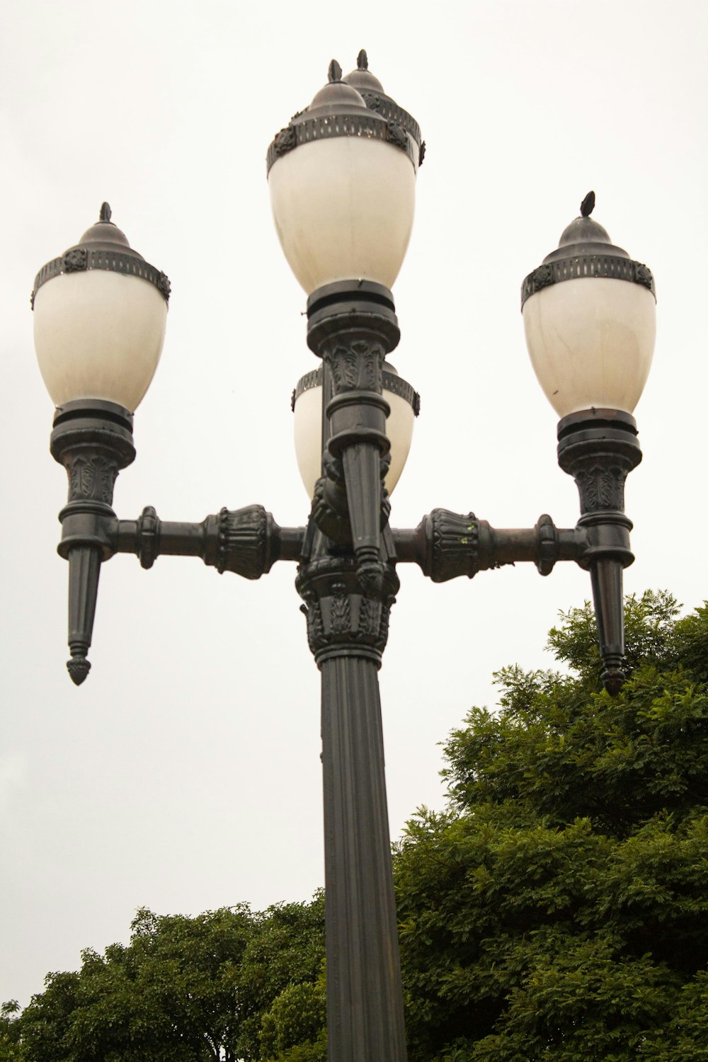 a lamp post with three lights on top of it