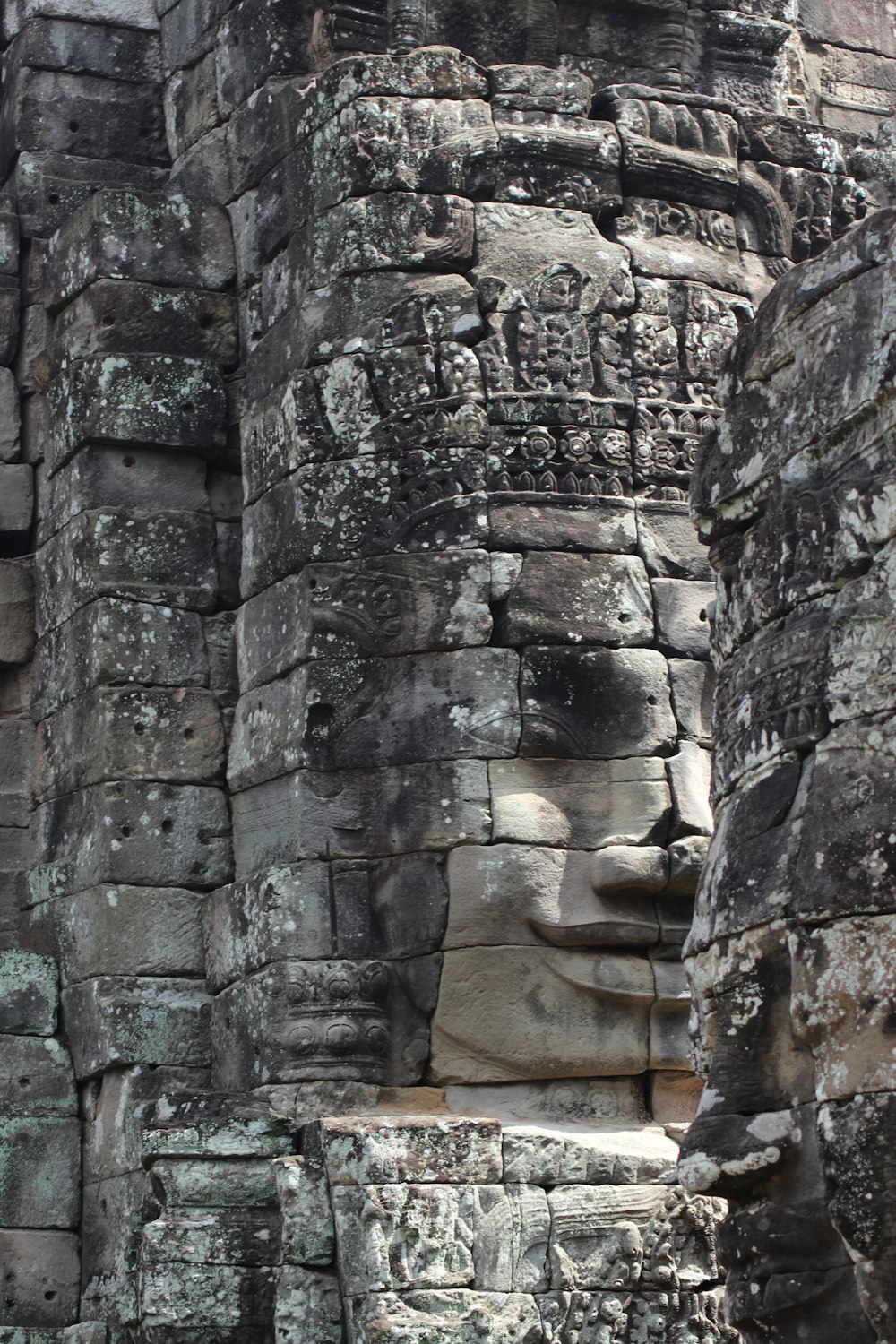 a face carved into the side of a stone building