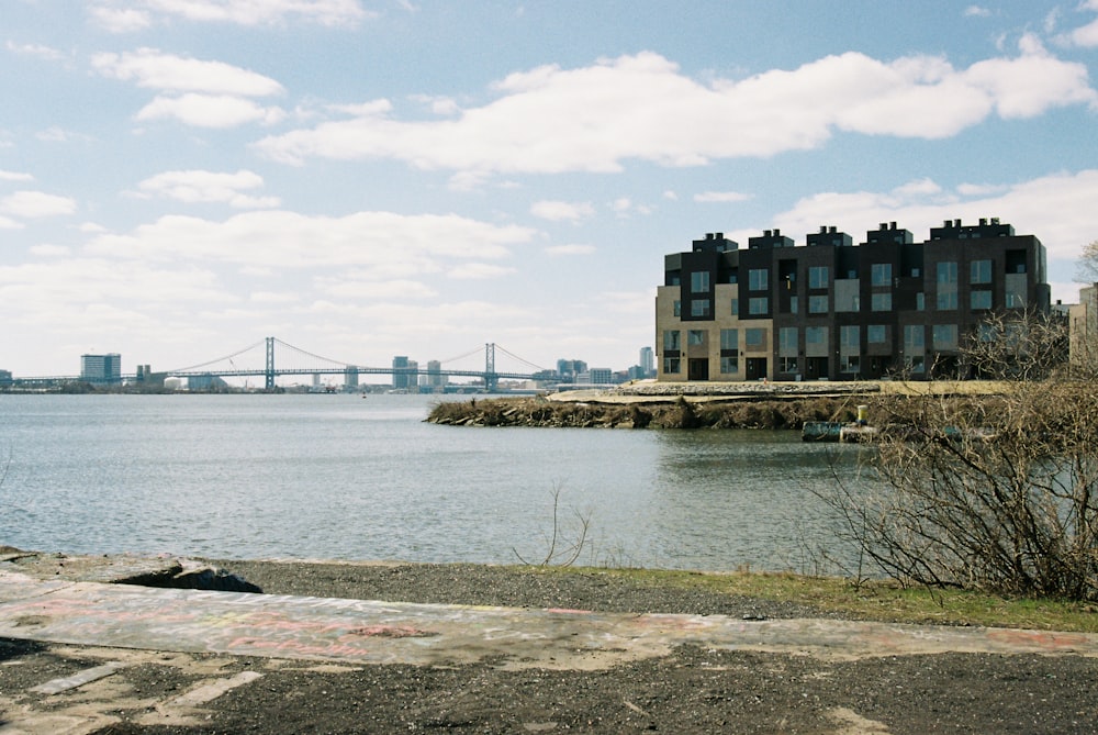 a large body of water with a bridge in the background