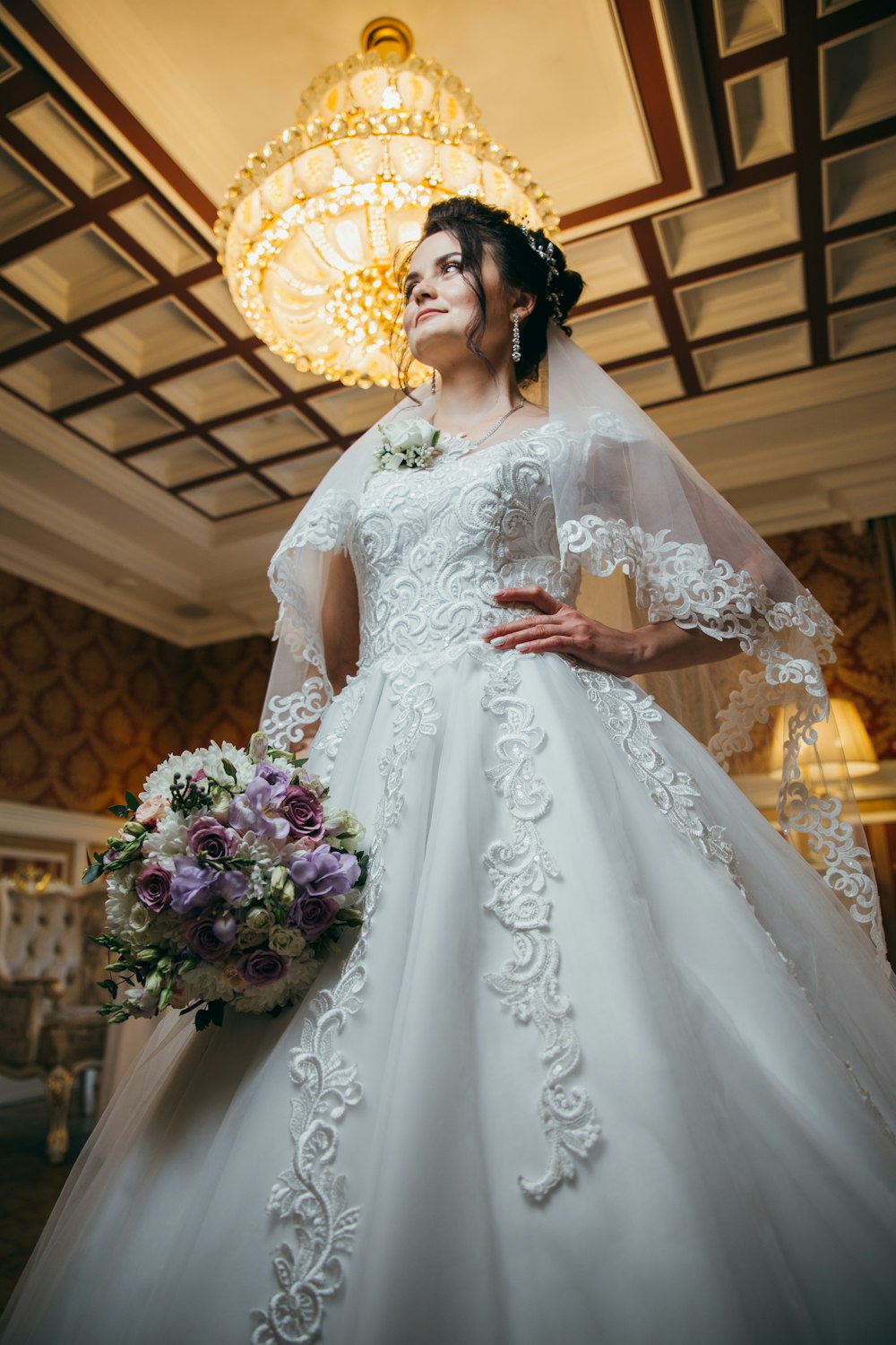 a woman in a wedding dress standing in a room