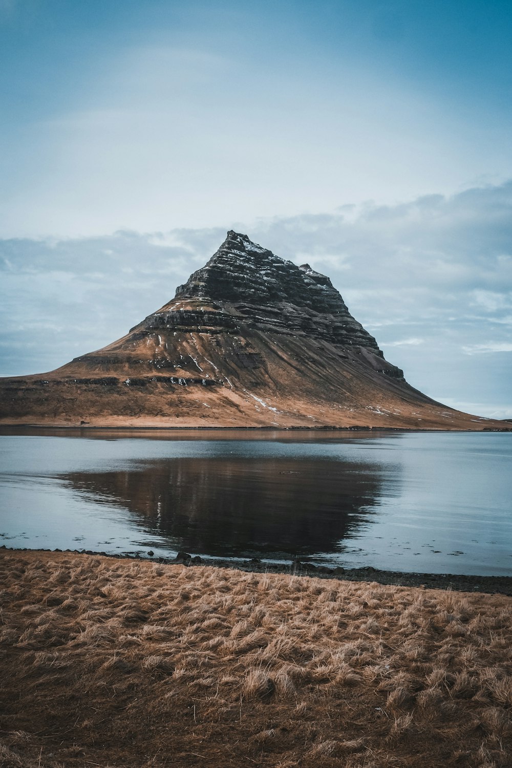 a mountain with a body of water in front of it