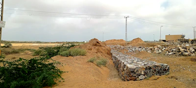 Wide shot of desert terrain with scattered automated monitoring equipment and communication towers.