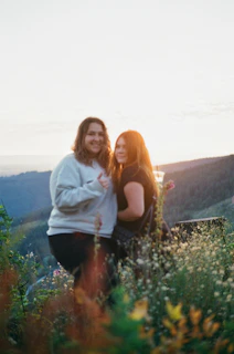 A candid photo of Cynthia and Pierre-Alain laughing together in a lilac field at sunset.
