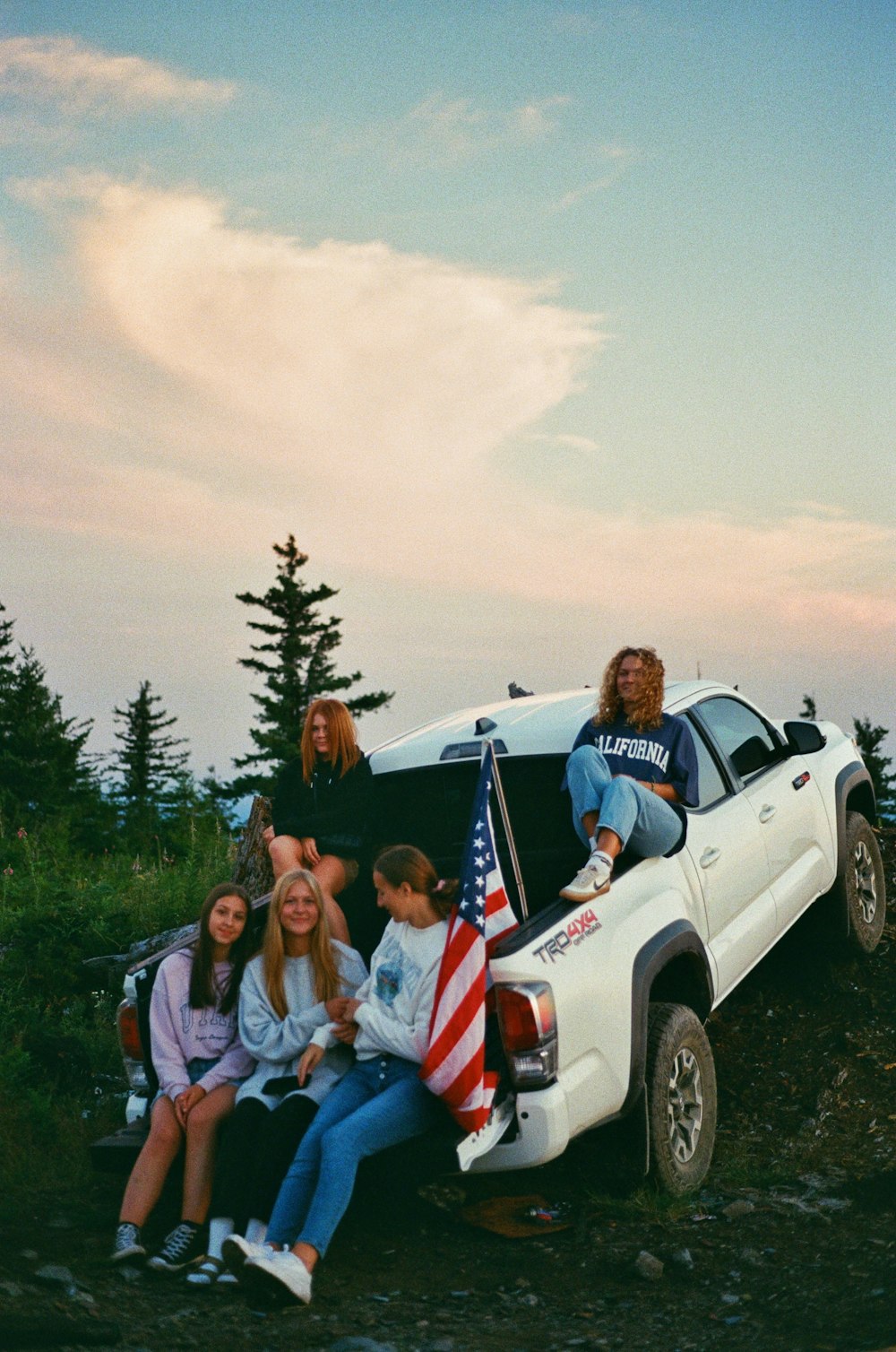 a group of people sitting in the back of a truck