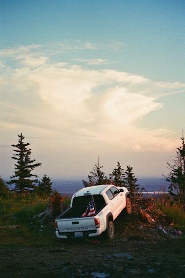 a white truck with an american flag on the back of it