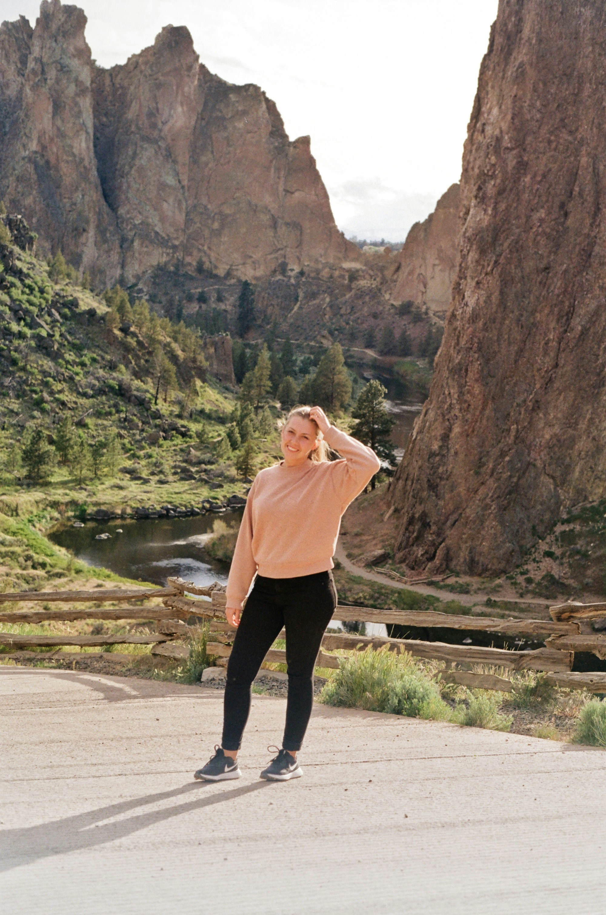 a woman standing in front of a mountain