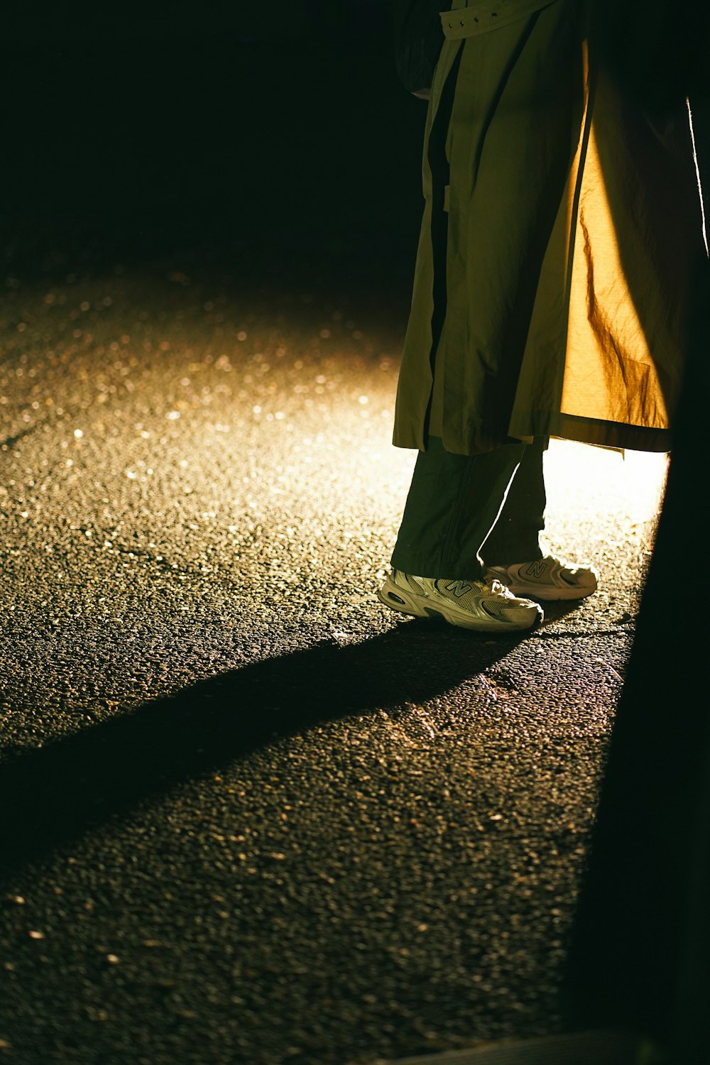 a person standing on a street at night