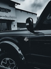 Poppa Dent van parked outside a home, technician unloading tools for mobile repair.