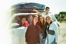 A group of college students discussing ride options.