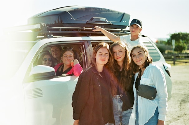 A family enjoying their time in an SUV rented from Oliver Rental Cars.