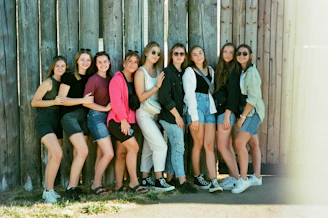 A group of smiling young girls participating in a safety workshop outdoors.