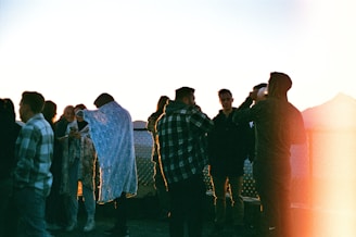 Volunteers and staff sharing a warm group moment outdoors during a community event.