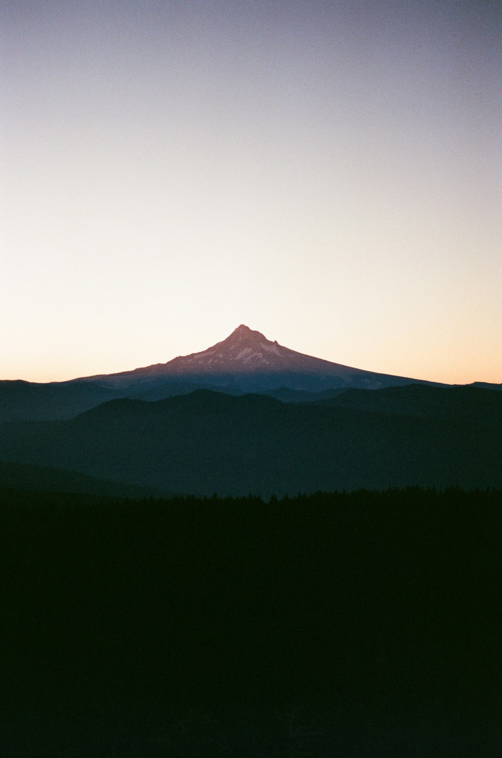 a view of the top of a mountain at sunset