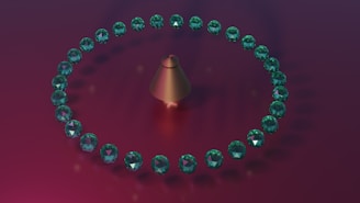 A circular arrangement of green gemstones surrounds a metallic, cone-shaped object on a gradient background transitioning from purple to dark red.