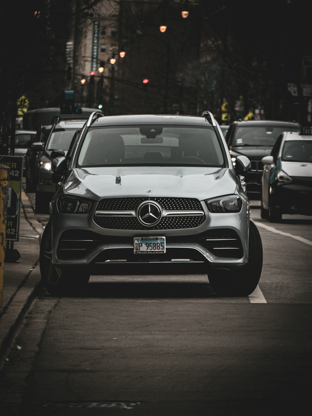 a mercedes car is parked on the side of the road