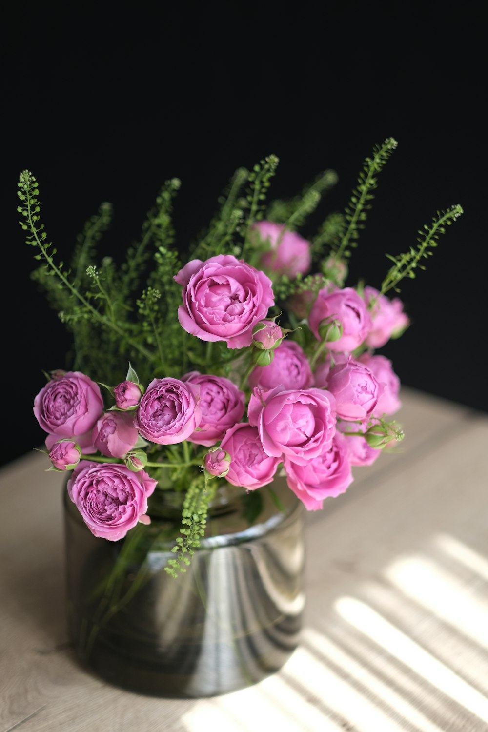 a vase filled with pink flowers on top of a table