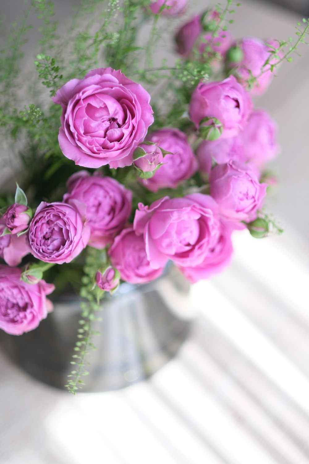 a vase filled with pink flowers on top of a table