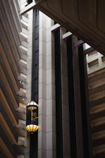Modern villa elevator shaft with glass walls illuminated by soft natural light.